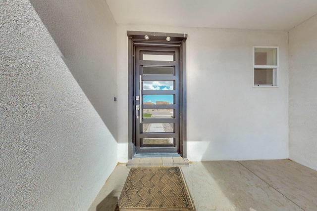 doorway to property with stucco siding