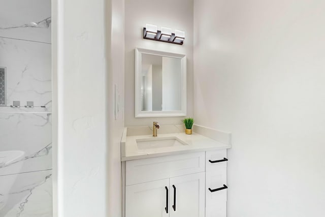 bathroom with a marble finish shower and vanity