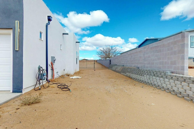 view of yard featuring a gate and fence