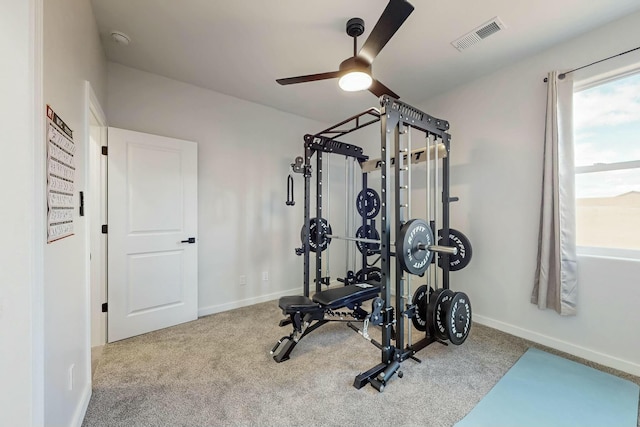 workout area with visible vents, baseboards, carpet flooring, and a ceiling fan