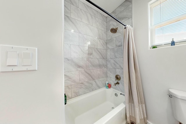 bathroom with toilet and shower / tub combo with curtain