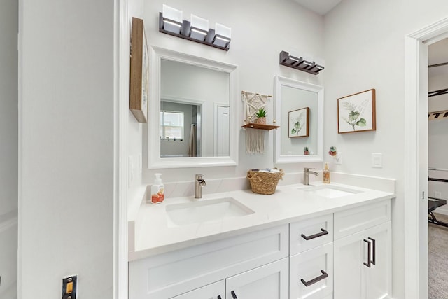 full bathroom with a sink and double vanity