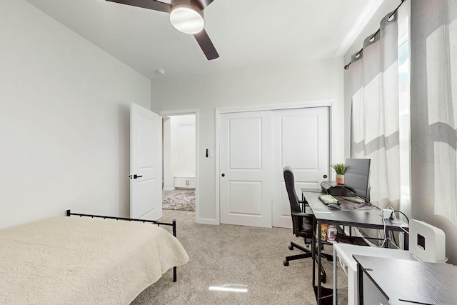 carpeted bedroom with a closet and ceiling fan