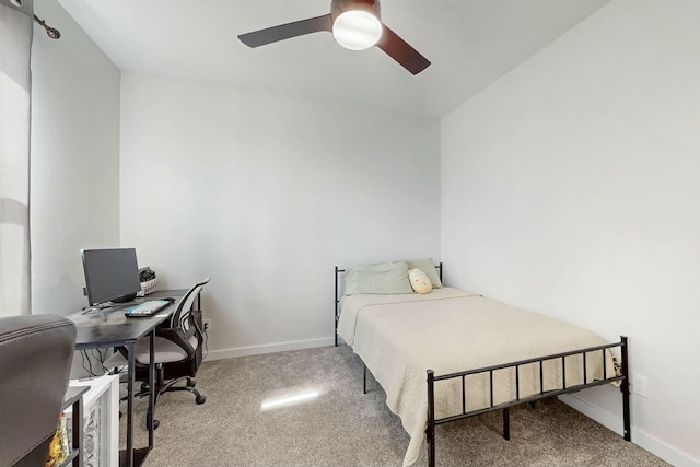 carpeted bedroom with baseboards and a ceiling fan