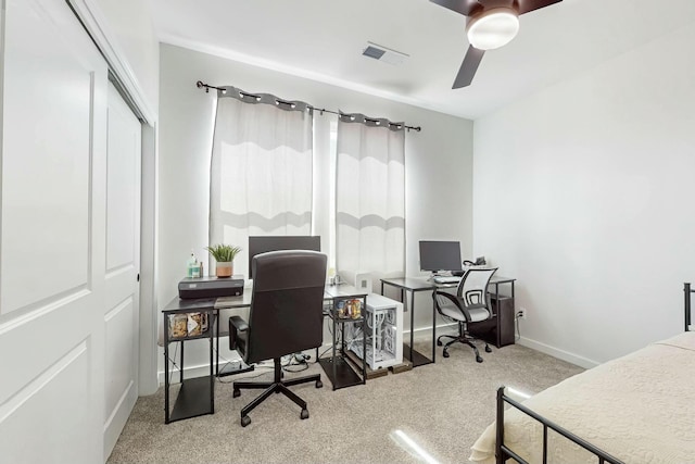 home office with visible vents, carpet floors, baseboards, and a ceiling fan