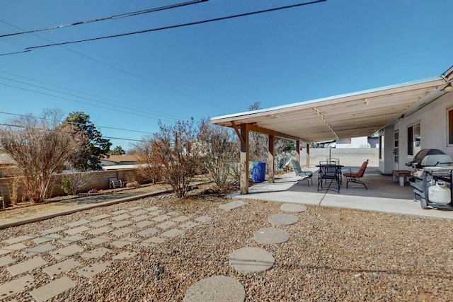 view of yard with a patio area, outdoor dining space, and a fenced backyard