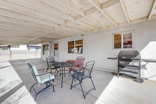 view of patio with area for grilling and outdoor dining area