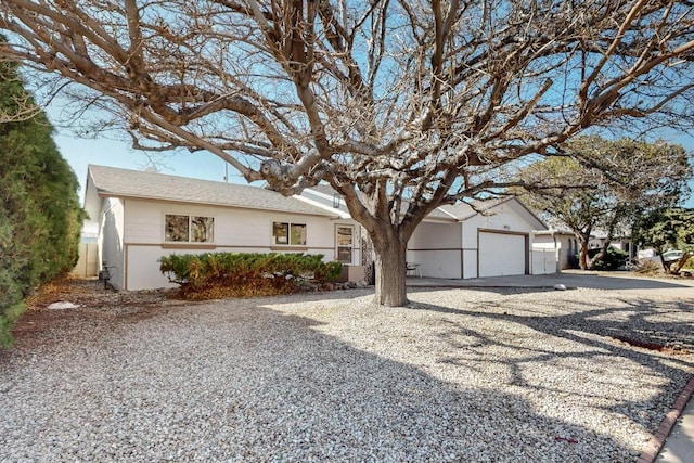 ranch-style house featuring aphalt driveway and a garage