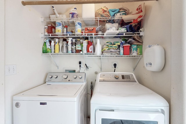 clothes washing area with washing machine and clothes dryer and laundry area