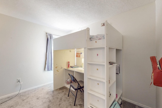 bedroom featuring baseboards, carpet, and a textured ceiling