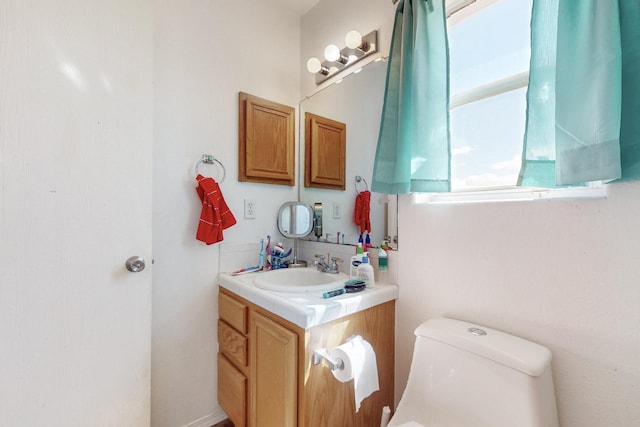 bathroom with toilet and vanity