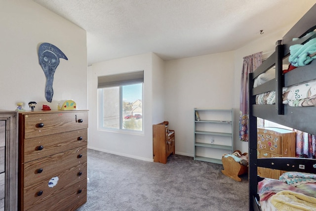 carpeted bedroom with baseboards and a textured ceiling