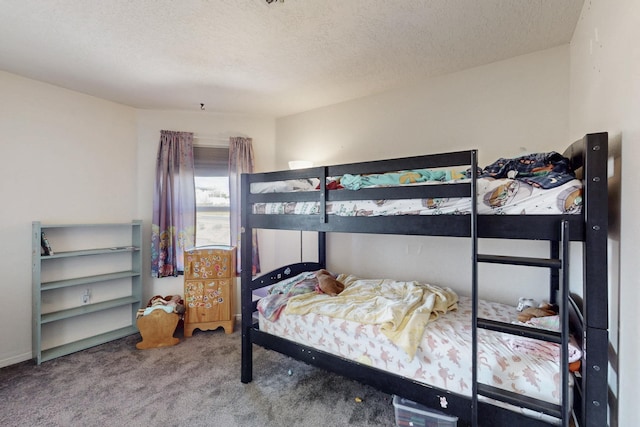 bedroom featuring carpet flooring and a textured ceiling