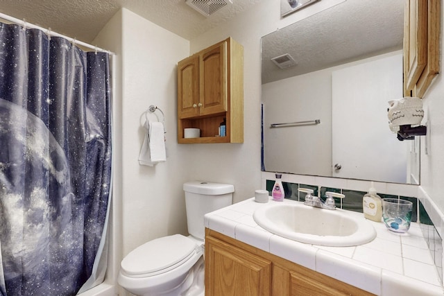 bathroom featuring toilet, visible vents, and a textured ceiling