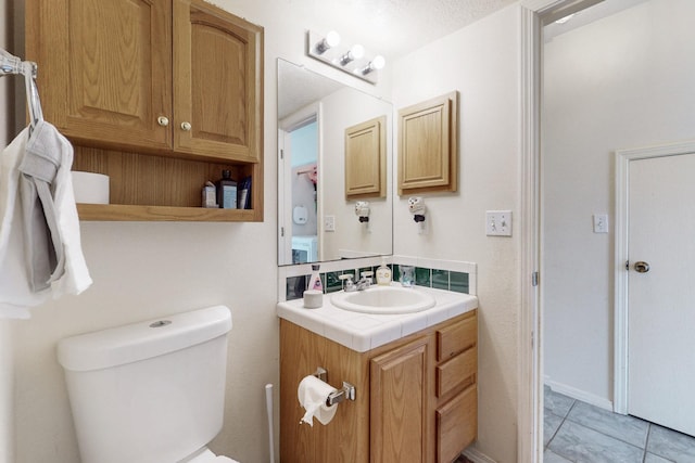 half bath featuring toilet and vanity