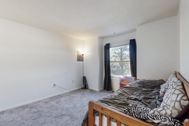 bedroom with a textured ceiling, baseboards, and carpet