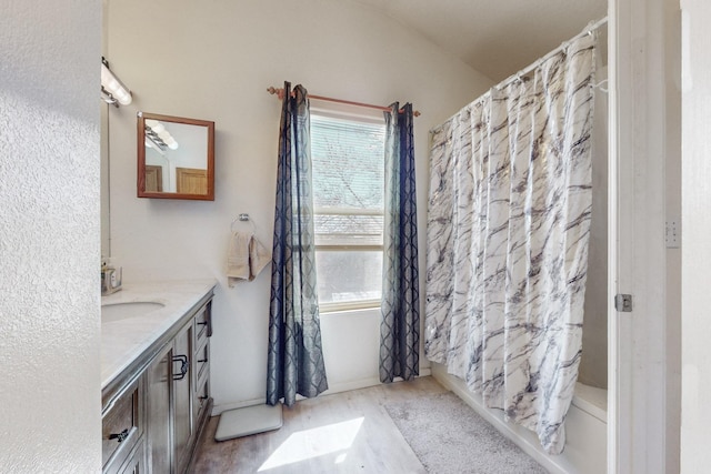 full bathroom featuring a shower with shower curtain, wood finished floors, and vanity