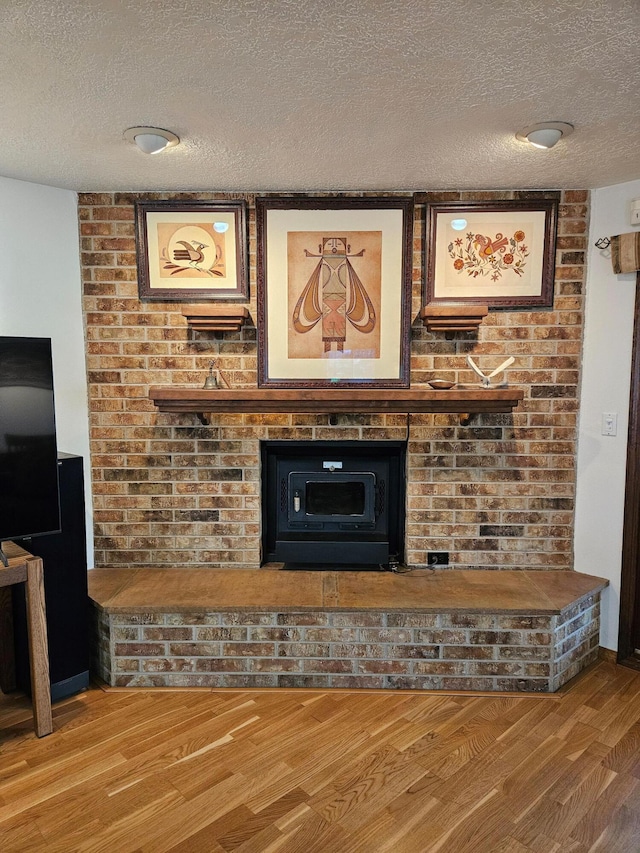 room details with wood finished floors and a textured ceiling