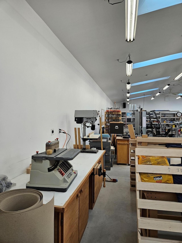 kitchen featuring concrete flooring and vaulted ceiling