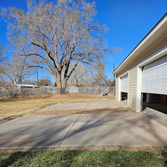 exterior space featuring a garage and fence