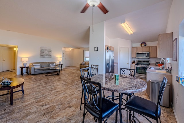 dining space featuring vaulted ceiling and ceiling fan