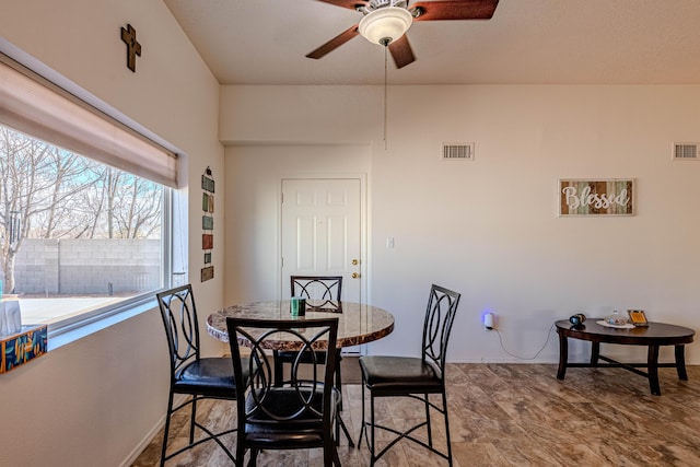 dining area with a ceiling fan and visible vents