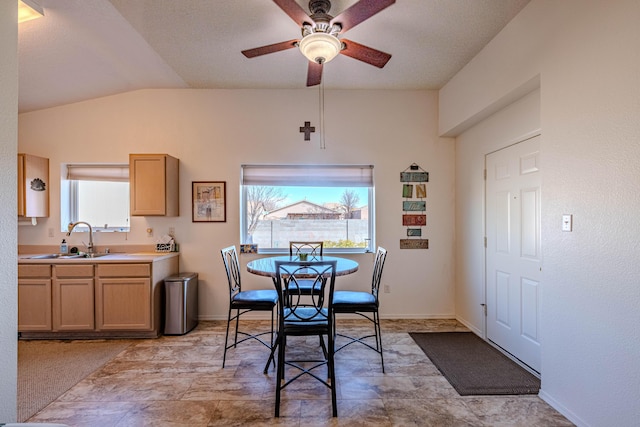 dining space with baseboards, ceiling fan, and vaulted ceiling