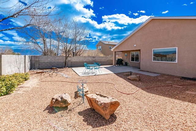 view of yard with a fenced backyard and a patio