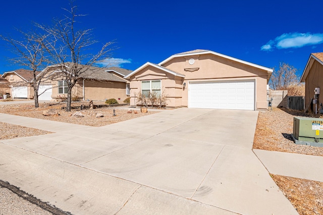 ranch-style house with fence, a garage, driveway, and stucco siding