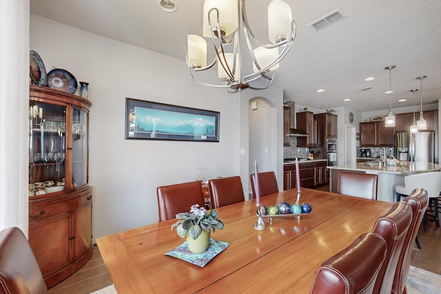 dining space featuring recessed lighting, visible vents, and an inviting chandelier