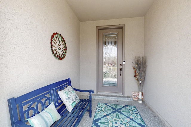 entrance to property featuring stucco siding