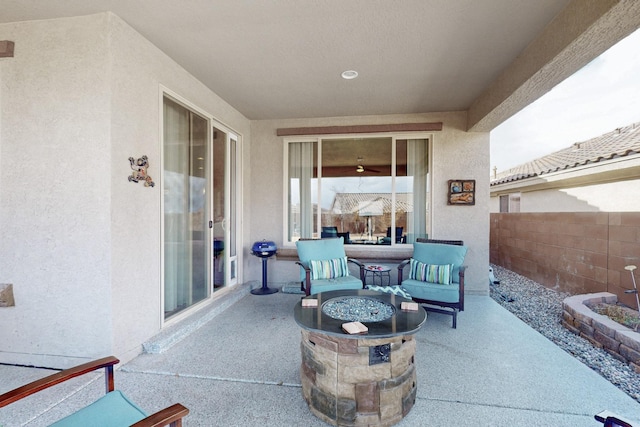 view of patio with a fire pit and fence