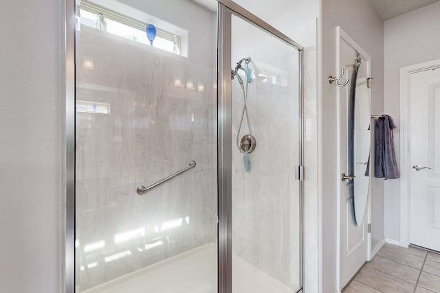 bathroom with tile patterned floors and a shower stall