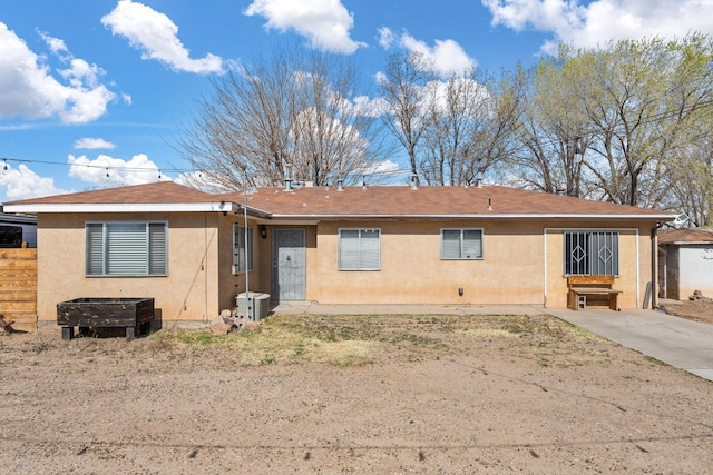 view of front of house with central air condition unit and stucco siding