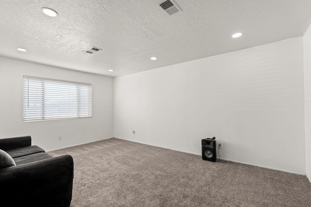 sitting room featuring recessed lighting, visible vents, carpet floors, and a textured ceiling