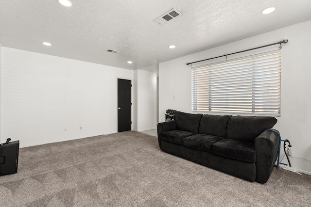 carpeted living room with recessed lighting, visible vents, and a textured ceiling