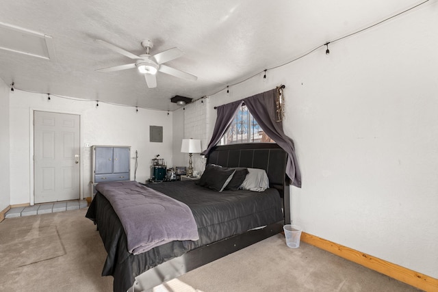 carpeted bedroom featuring ceiling fan, baseboards, attic access, electric panel, and a textured ceiling