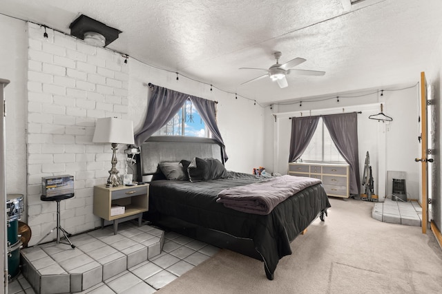 bedroom with a textured ceiling, ceiling fan, and carpet