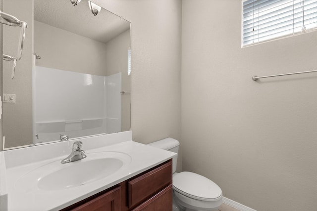 bathroom featuring a shower, a textured ceiling, toilet, and vanity