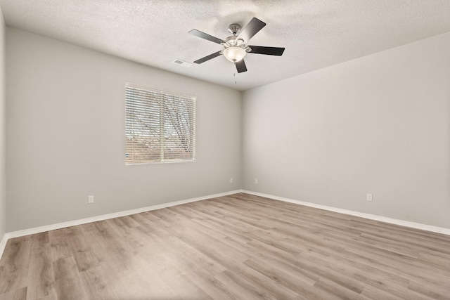 empty room with wood finished floors, baseboards, and ceiling fan