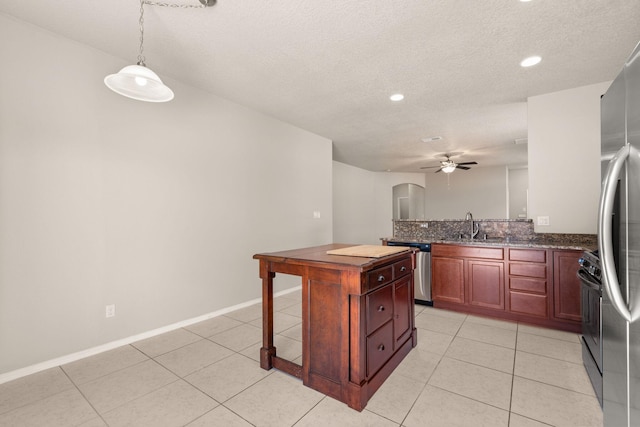 kitchen featuring arched walkways, appliances with stainless steel finishes, light tile patterned flooring, and a ceiling fan