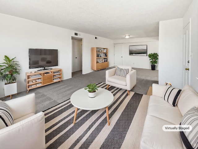 carpeted living room with visible vents and a textured ceiling