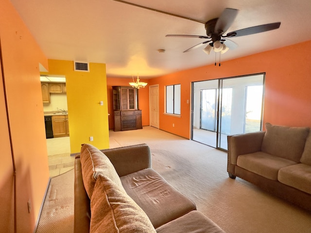 living room with light colored carpet, ceiling fan with notable chandelier, and visible vents