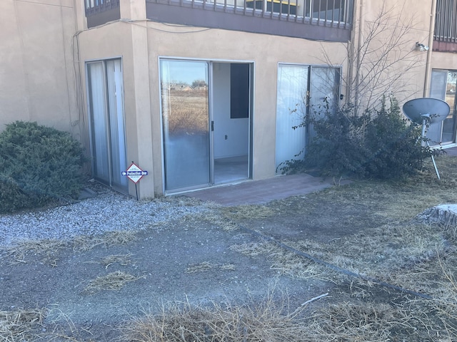 entrance to property with stucco siding