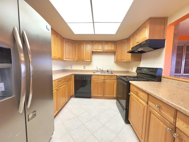 kitchen with a sink, decorative backsplash, black appliances, light countertops, and under cabinet range hood