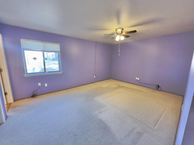 unfurnished room featuring light carpet and ceiling fan