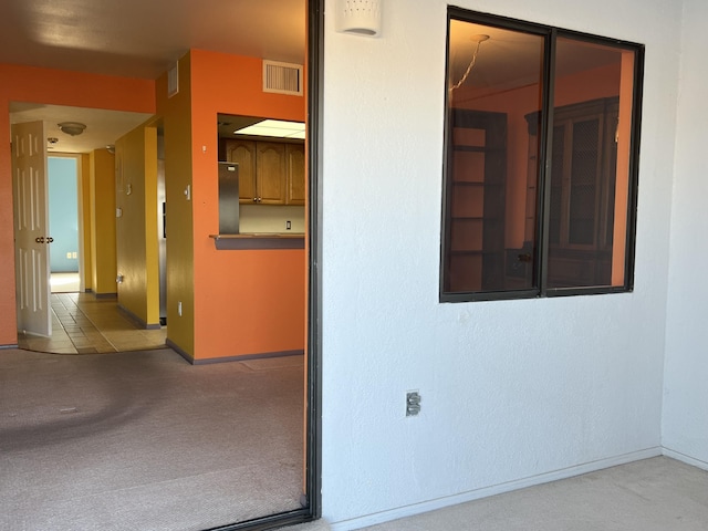 interior space with visible vents, baseboards, and carpet