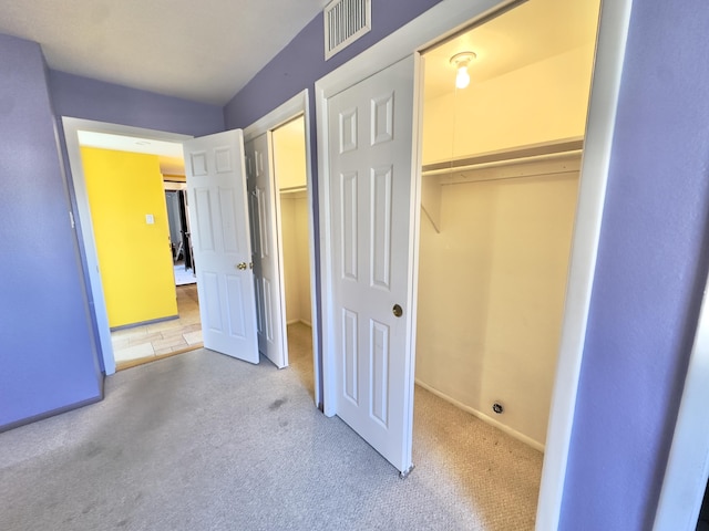 unfurnished bedroom with visible vents, carpet flooring, and baseboards