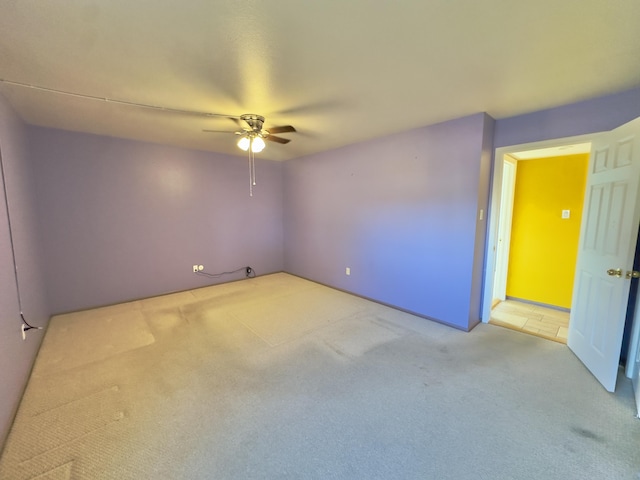 carpeted empty room with ceiling fan