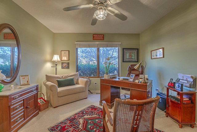 office area featuring light carpet and ceiling fan